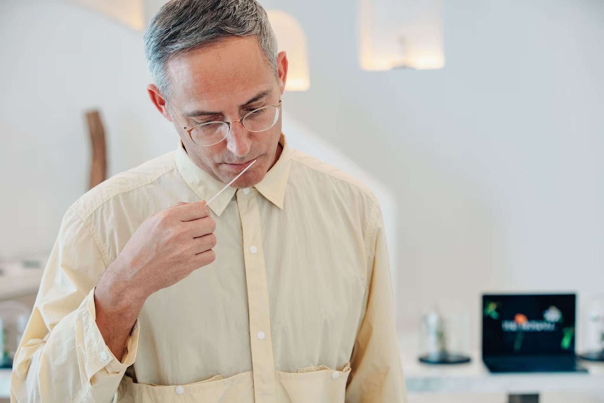 A man wearing glasses is looking at a piece of paper